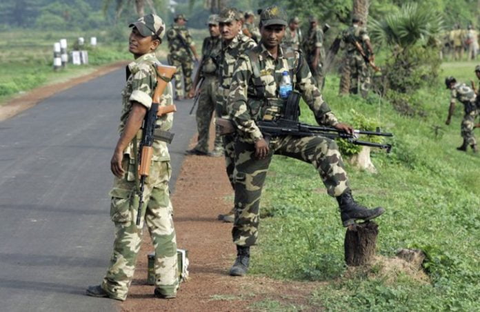 Paramilitary soldiers patrol deserted road as they move towards Lalgarh in West Midnapore district