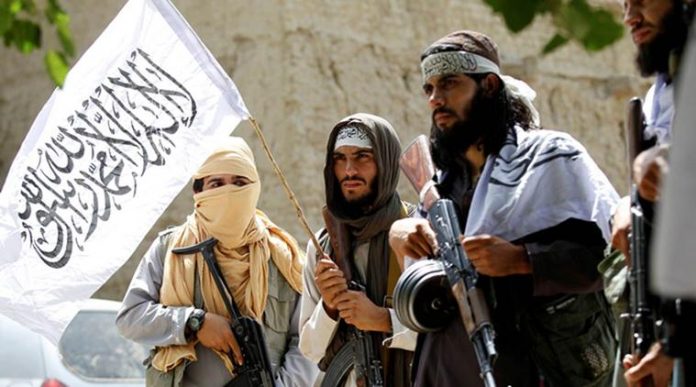 FILE PHOTO:Taliban walk as they celebrate ceasefire in Ghanikhel district of Nangarhar province, Afghanistan